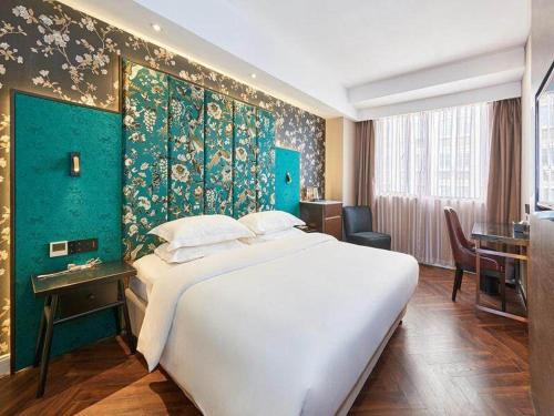 Ліжко або ліжка в номері Metropolo Hotel Jiangyin Hongqiao Road Baiye Plaza