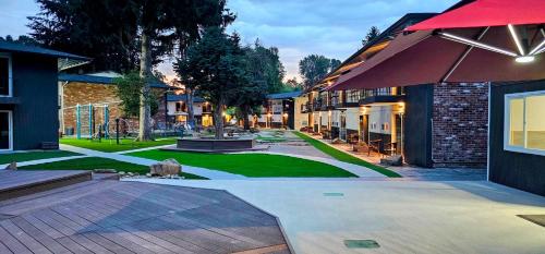 a courtyard of a building with an umbrella at Interurban Suites Hotel in Tukwila