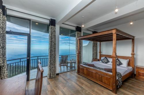 a bedroom with a bed and a balcony at leisure Mount View in Haputale