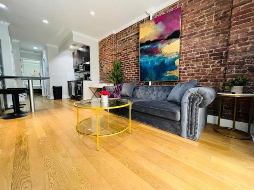 a living room with a couch and a glass table at Midtown Luxe in New York