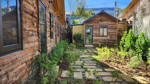 a stone walkway between two buildings next to a building at MoCha House in Làng Môn