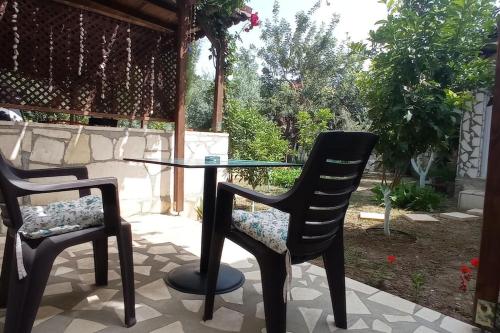 two chairs and a glass table in a patio at Finike Apart Orion in Finike