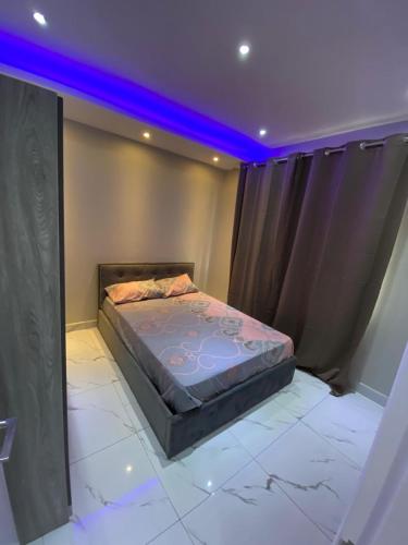 a bedroom with a bed with purple lights on it at 3 BD Luxury Beachfront Penthouse in Flic-en-Flac