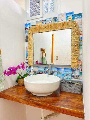 a bathroom with a white sink and a mirror at Casa Palmar Point in San Carlos