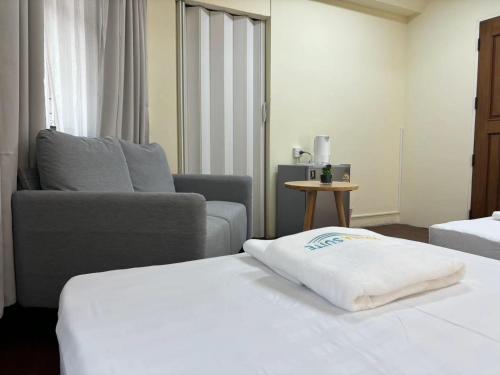 a hotel room with a bed and a couch at Apamet Hotel Sukhumvit 55 in Khlong Toei