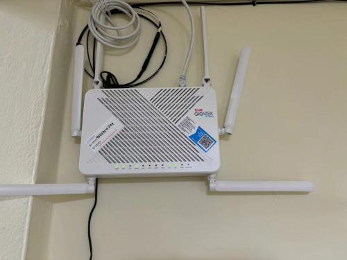 a laptop sitting on top of a wall at Apamet Hotel Sukhumvit 55 in Khlong Toei