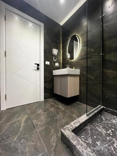 a bathroom with a shower and a sink and a mirror at Onyx Pyramids Boutique Hotel in Cairo