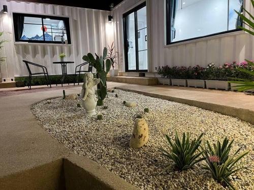 a garden with statues of cats and plants in a building at 独立庭院 花园式的两卧两卫民宿 近mrt 2 in Bang O