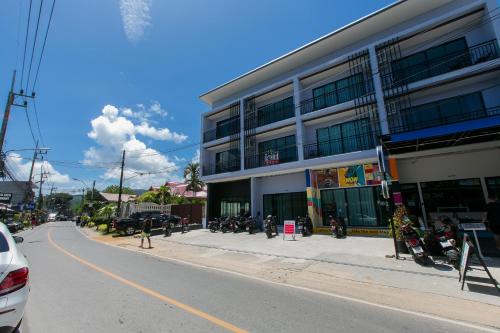 a building with motorcycles parked on the side of a street at Wow Academy & Stay Soi Tai-Aed 3B in Ban Suan