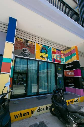 a motorcycle parked in front of a gas station at Wow Academy & Stay Soi Tai-Aed 2B in Ban Suan