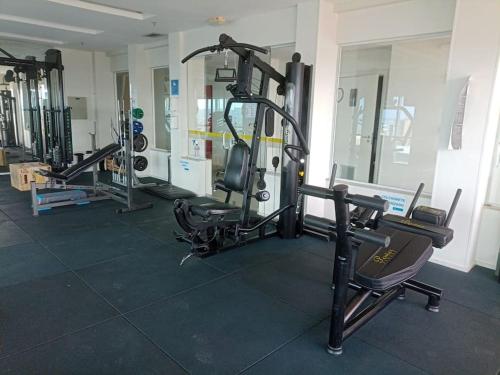 a gym with several tread machines in a room at Flat Particular Marizienne Hotel Saint Moritz 31 in Torto