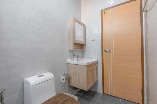 a bathroom with a toilet and a sink and a mirror at Sunflower Pool Villa Central Pattya in Pattaya South