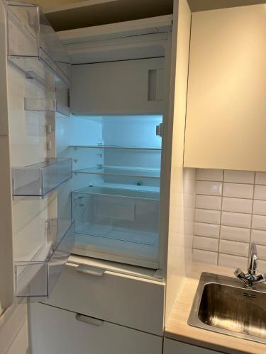 a small kitchen with a sink and a sink at Beach Guest House in Greve