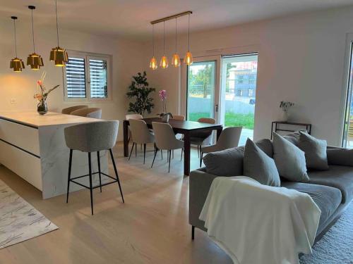 a living room with a couch and a table at Luxury lakeside home Geneva Lausanne in Rolle