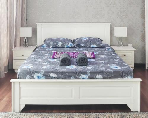 a white bed with two pug pillows on it at Homestay Vista Alam in Shah Alam