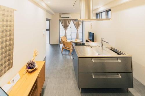 a kitchen with a sink and a counter at 那覇 国際通りまで30秒 1日1組限定のモダン貸切ステイ in Naha