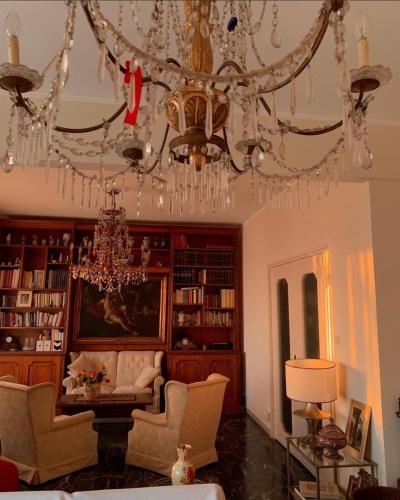 a chandelier in a living room with a couch and chairs at Genoa view & hiking in italian riviera in Genoa
