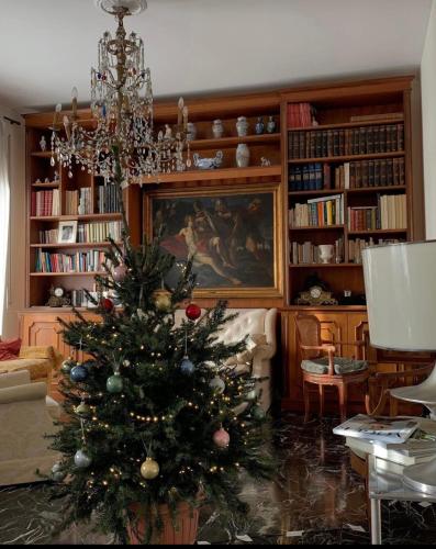 a christmas tree in a living room with a chandelier at Genoa view & hiking in italian riviera in Genoa