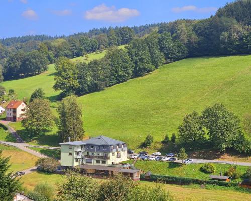 an aerial view of a house in a green field at Hotel Grüner Baum mit Restaurant & Wellness in Beerfelden