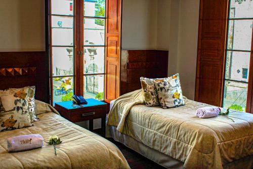 Ένα ή περισσότερα κρεβάτια σε δωμάτιο στο Hotel Tikary