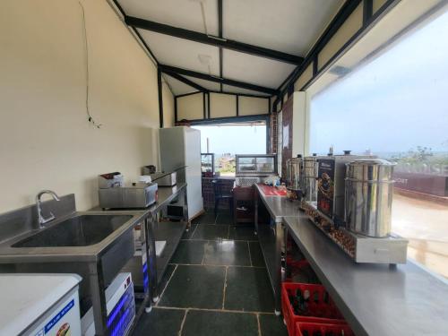 a kitchen with a sink and a counter top at PALM PARADISE Beach Resort in Puducherry