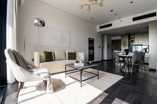 a living room with a couch and a table at Stylish 1BR with Dubai Skyline & Burj Khalifa View in Dubai