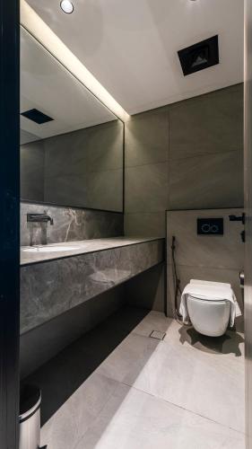 a bathroom with a toilet and a sink at Stylish 1BR with Dubai Skyline & Burj Khalifa View in Dubai