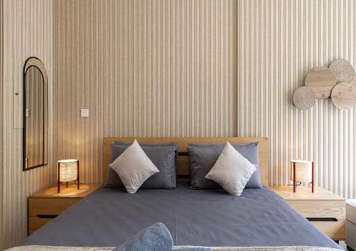 a bedroom with a bed with blue sheets and pillows at Apartment With Private Garden - Luxe Gold in Sharjah