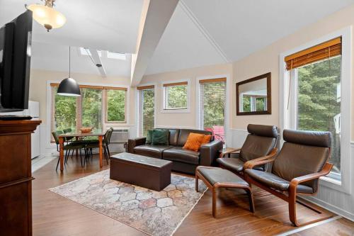 a living room with a couch and a table at Tremblant Ski InOut Pedestrian Village in Mont-Tremblant