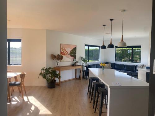a kitchen and living room with a couch and a table at Brooklyn Views in Feilding