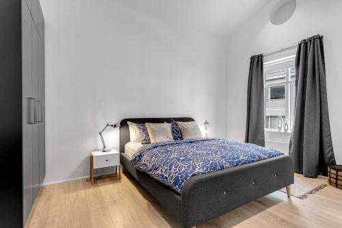 a bedroom with a bed and a window at Luxury penthous - 3 BR - 2 Bath - FreeParking - Downtown in Reykjavík