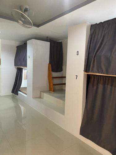 a room with two bunk beds and a window at Dante's Hideaway Guest House in Boracay