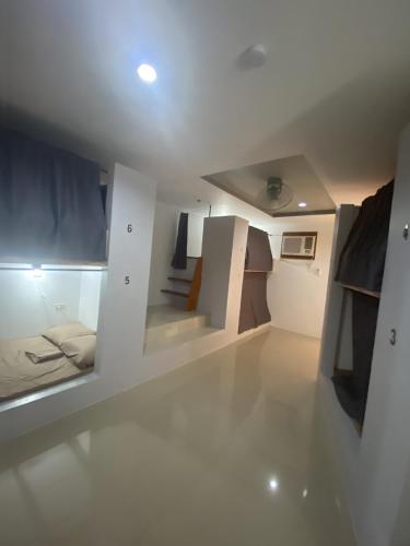 a room with a bed and stairs in it at Dante's Hideaway Guest House in Boracay