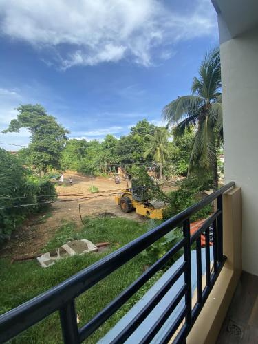 a balcony with a view of a field at Dante's Hideaway Guest House in Boracay