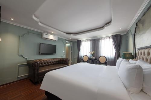 a hotel room with a bed and a couch at Madelise Grand Hotel in Hanoi