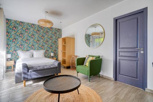 a bedroom with a bed and a chair and a table at Superbe studio avec terrasse in Brunoy
