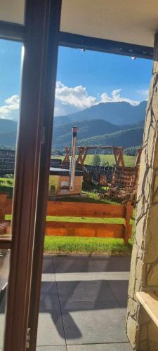 a view of a view from a window with a bench at Good Morning Giewont & JACUZZI in Kościelisko