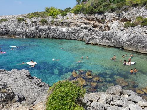a group of people swimming in a body of water at Mary appartament in Marina di Camerota