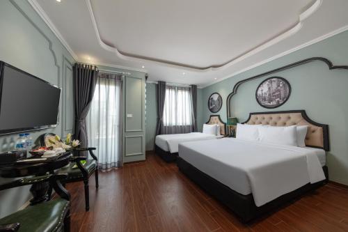 Postel nebo postele na pokoji v ubytování Madelise Grand Hotel