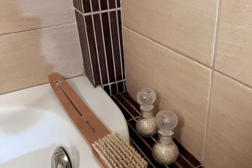 a close up of a bathroom sink with vases on it at Kosta's elegant house in Kánithos