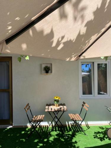 a patio with two chairs and a table with flowers at Civico 38 Pescara in Pescara