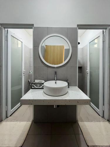 a bathroom with a sink and a mirror at Spacious 3BR Villa Near Kaliurang - Arfani's House in Ngaglik