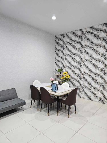 a dining room with a table and chairs at K Siri House Hatyai in Hat Yai