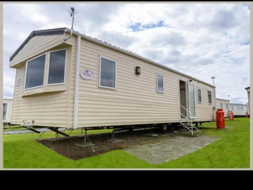 a mobile home is parked in a yard at Whitley Bay Caravan in Hartley