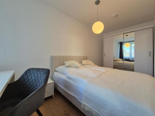 a bedroom with a large bed and a mirror at Modern City Apartment 1 in Munich