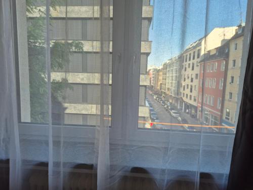 a window with a view of a city street at Modern City Apartment 1 in Munich