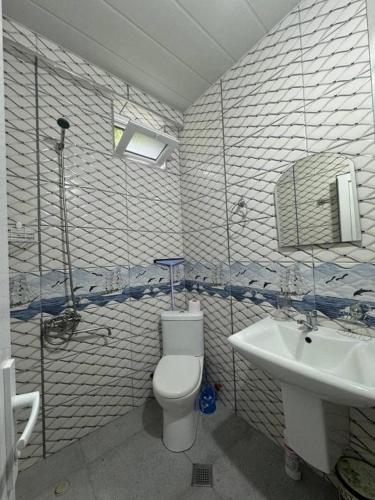 a bathroom with a toilet and a sink at Villa Royal Realm in Batumi