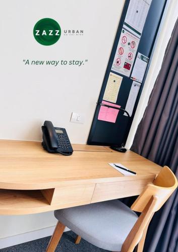 a desk with a phone sitting on top of it at Zazz Urban Ho Chi Minh in Ho Chi Minh City