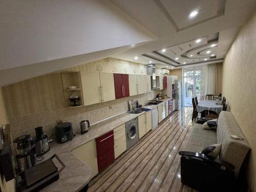 a large kitchen with a couch and a table at Baku Private Villa in Baku