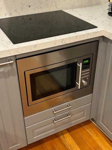 a microwave oven in a kitchen with a counter top at Regents Gate East Melbourne in Melbourne